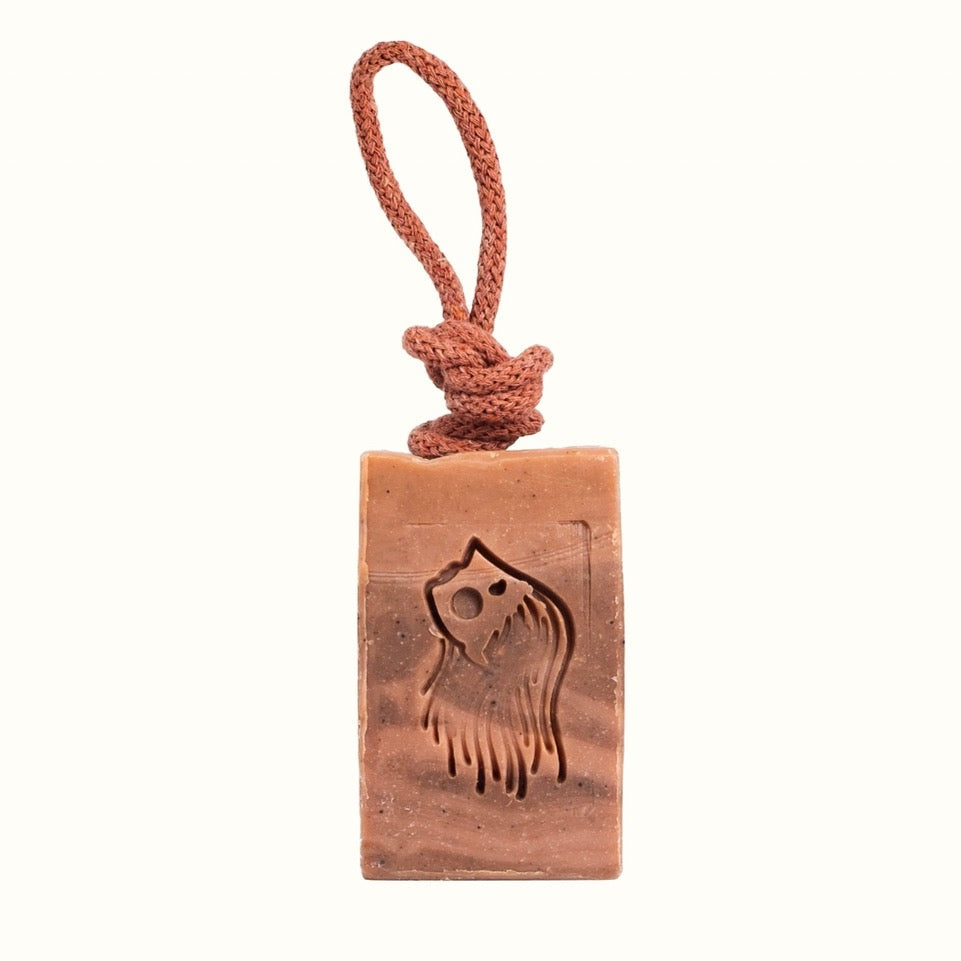 Rectangular soap bar with a rope on a white background