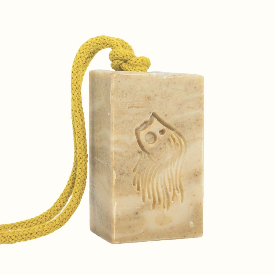 Bar of soap with a yellow rope on a white background