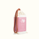Bag of goat milk soap with pink label on a white background